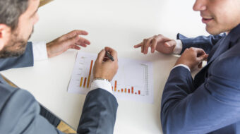 close-up-businessmen-working-company-financial-report-white-desk