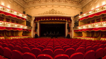 Vinnitsa,Ukraine - December 13,2015. The interior of Central Golden Hall in empty theater with red seats and balcony